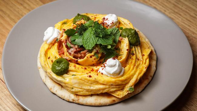 Ivy and Pearl’schilli folded eggs on charred flatbread with fried bacon, Aleppo pepper, spring onion, Persian fetta and green harissa. Picture: Nicole Cleary