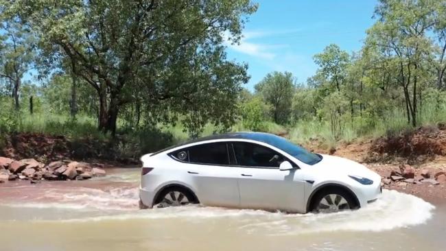 The Tesla Y taking on a flood affected bit of road on Mr Murphy's trip. Picture: Twitter