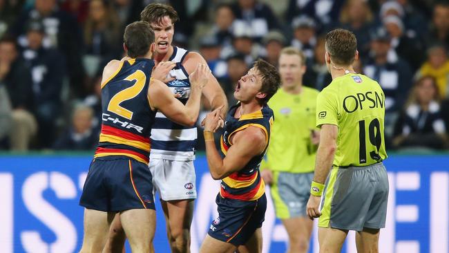 TAG TEAM: Adelaide’s Brad, left, and Matt Crouch remonstrate with Geelong’s Tom Hawkins. Picture: Getty Images