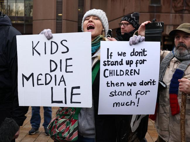 Protesters hold placards as they demonstrate in front of members of the media outside of The Queen Elizabeth II Law Courts in Liverpool, north west England on January 23, 2025, ahead of the sentencing Southport attacker Axel Rudakubana. Picture: AFP