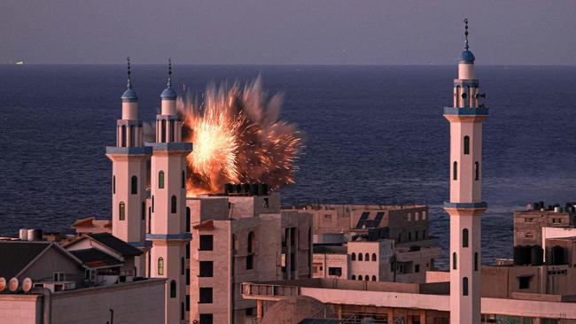 A fireball erupts from a building hit by an Israeli air strike on Friday (AEDT). Picture: AFP