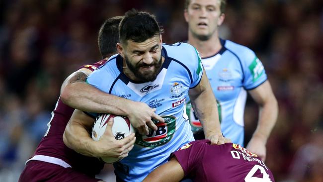 NSW's Josh Mansour attempts to bust the tackle of QLD's Justin O'Neill during State of Origin Game 2 between the NSW Blues and the Queensland Maroons at Suncorp Stadium, Brisbane. Picture: Gregg Porteous