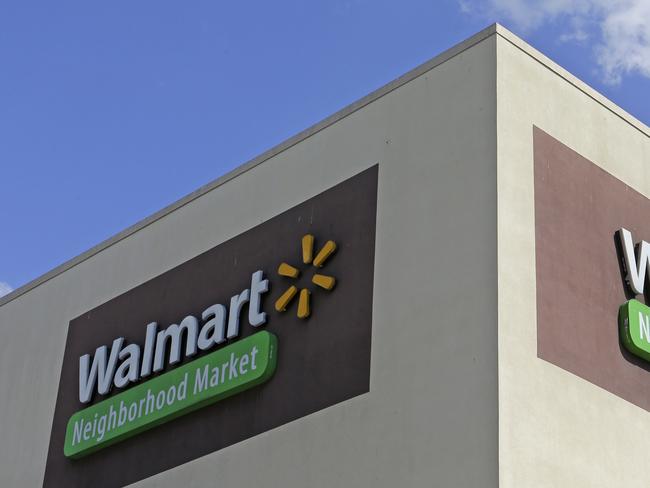 FILE - This Wednesday, Feb. 8, 2017, file photo shows Walmart signage at one of the company's neighborhood markets in Hialeah, Fla. Wal-Mart Stores, Inc. reports earnings, Thursday, Nov. 16, 2017. (AP Photo/Alan Diaz, File)