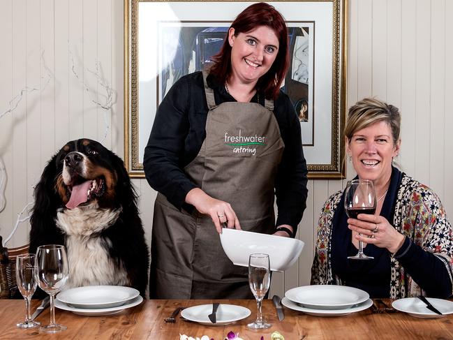 Brick the dog gets ready for a feast at Blue Moon Cottages with Freshwater Catering chef Jacqui Poultier and Louise Georgeson. Picture: Mark Dadswell