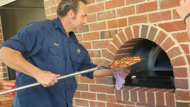 Michael Laubli cooking pizzas in the upgrade wood-fired ovens in Hovell Tree Park.