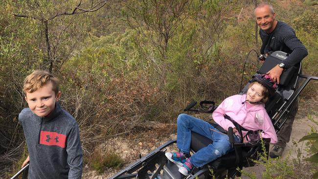 Paul Grant, son Cody, 10 and daughter Zoe, 13, who is using Yankalilla Council's new TrailRider at Deep Creek. Picture: Supplied