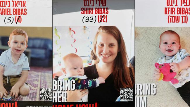 Posters bearing the portraits of Israeli hostages Shiri Bibas and her two children Ariel and Kfir set up on a square outside Tel Aviv Museum of Art, on January 21. Picture: AFP