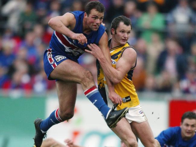 Brad Johnson boots the ball off the ground against the West Coast Eagles in 2002.