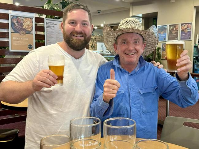 Walloon Hotel owner Stewart Gibson toasts with local legend Scotty who returned a number of glasses to the hotel. Picture: Walloon Hotel