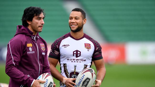 Former Queensland player Johnathan Thurston (left) and Moses Mbye (right) at Maroons training. Picture: AAP Image/Darren England