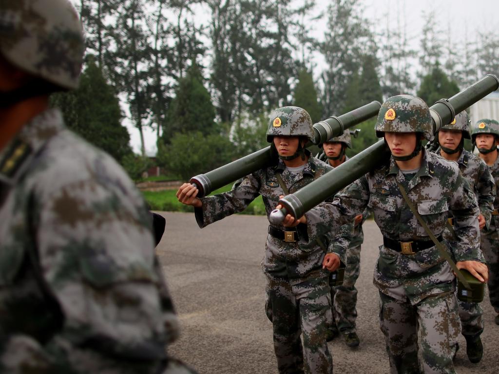 People’s Liberation Army (PLA) soldiers take part in a drill during a reporting trip to the Third Guard Division of the PLA in Beijing, China. Picture: Getty Images