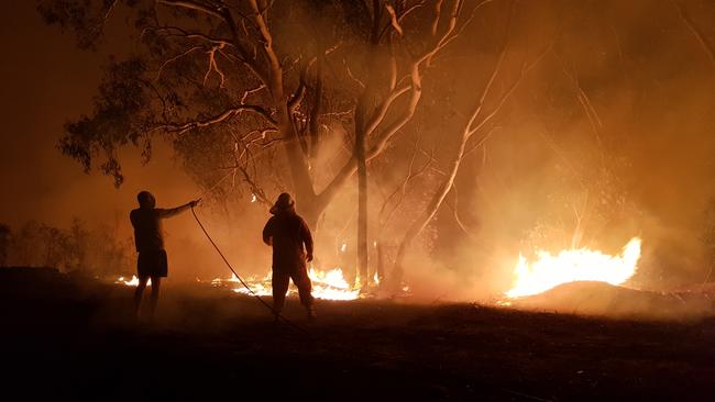 Firefighters and residents fought side-by-side near Menai with whatever they had.