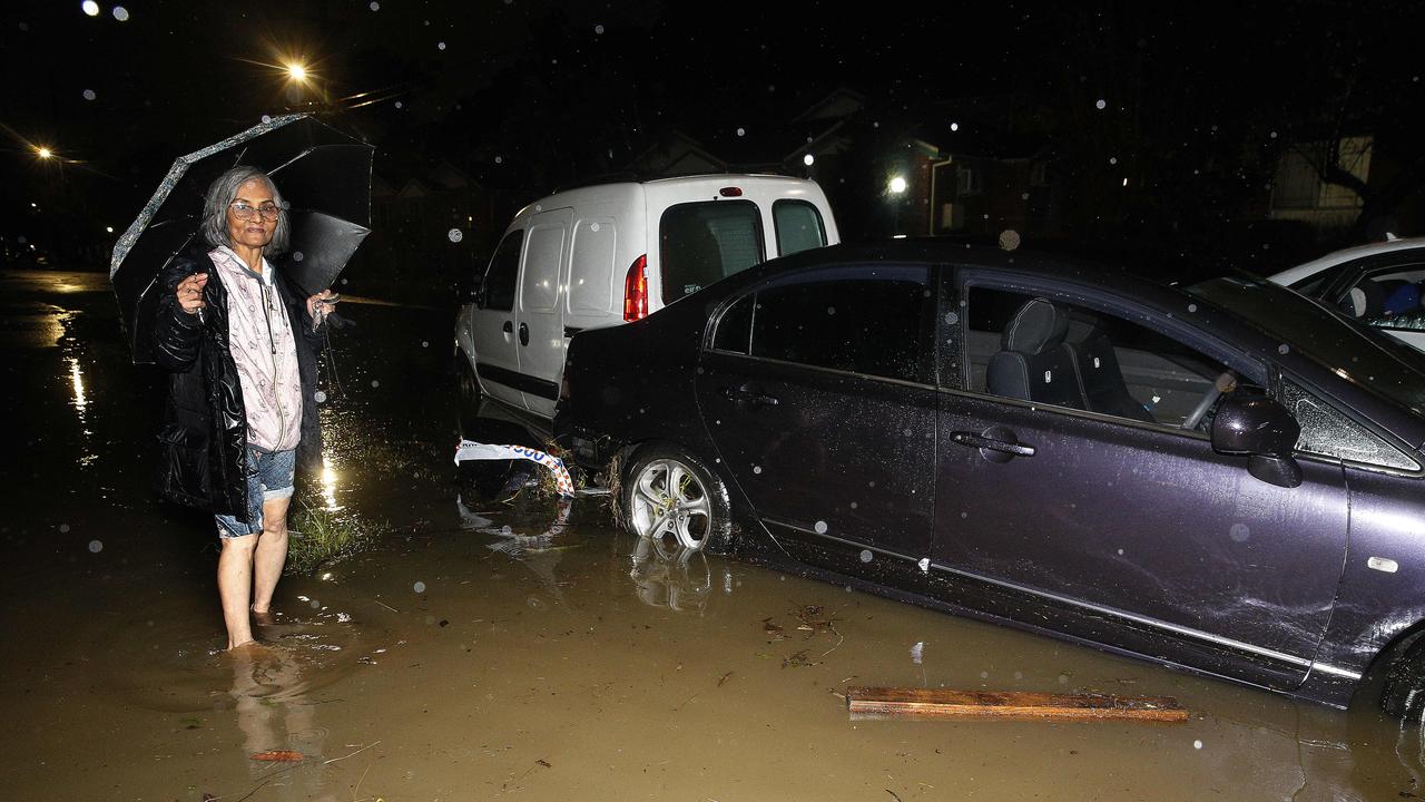 Tho Thi Ngo, 72, was carried in floodwaters in Freeman Ave, Canley Vale near other parked cars. Picture: John Appleyard