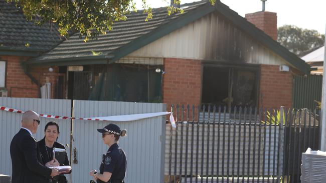 Police and detectives at the home in Elizabeth North after a house fire overnight. Picture: Russell Millard