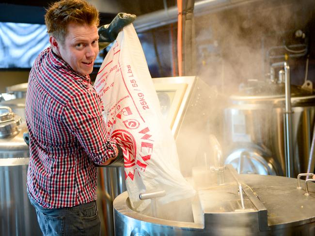 Bryn pours malt into the mash tun. Photo Jeremy Piper