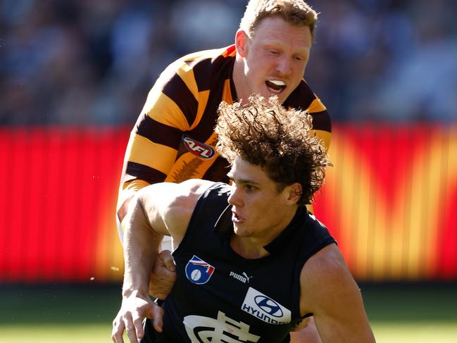 MELBOURNE, AUSTRALIA - AUGUST 11: Charlie Curnow of the Blues is tackled by James Sicily of the Hawks during the 2024 AFL Round 22 match between the Carlton Blues and the Hawthorn Hawks at The Melbourne Cricket Ground on August 11, 2024 in Melbourne, Australia. (Photo by Michael Willson/AFL Photos via Getty Images)