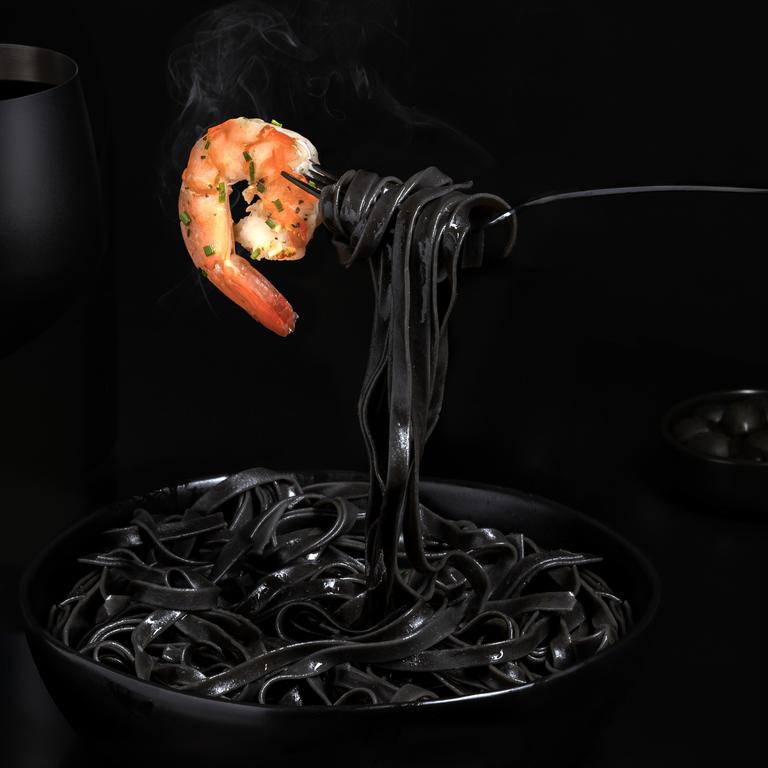 A marriage of dark and bold with light and sweet in the form of squid ink pasta with a delicate prawn. Picture: Orly Catz/Pink Lady® Food Photographer of the Year