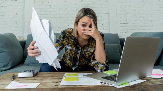 Portrait of desperate young woman feeling stressed checking online banking accounting home finances not able to pay off debts, mortgage, rent and expenses. In paying bills and financial problems.