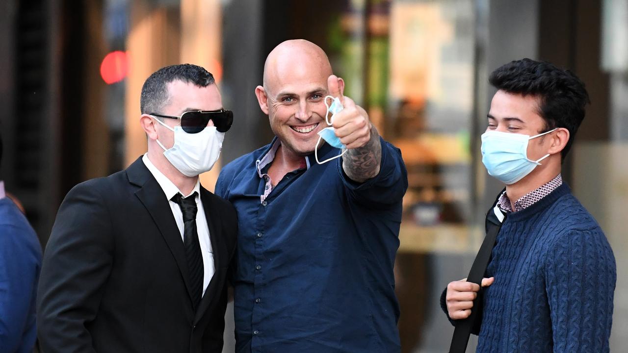 A supporter of brothers Nathan and Dru Baggaley gestures outside the Supreme Court in Brisbane. Picture: NCA NewsWire / Dan Peled