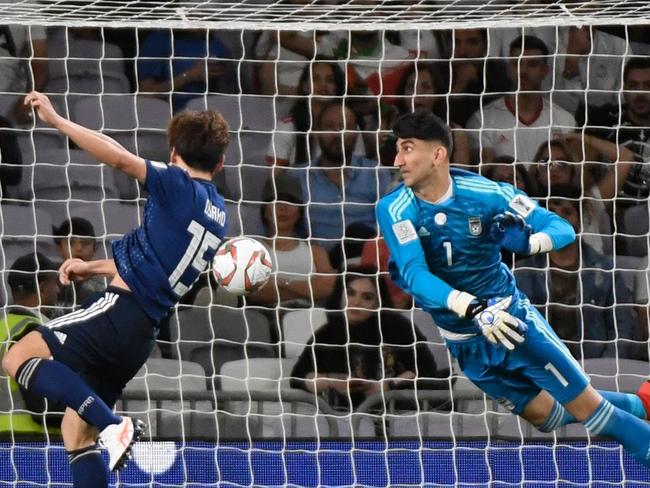 Japan's forward Yuya Osako (C) heads the ball to score during the 2019 AFC Asian Cup semi-final football match between Iran and Japan at the Hazza Bin Zayed Stadium in Abu Dhabi on January 28, 2019. (Photo by Khaled DESOUKI / AFP)