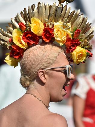 A racegoer prepares for the annual Fashion on the Field competition at Flemington Racecourse on Melbourne Cup day in Melbourne on November 3, 2015. RESTRICTED TO EDITORIAL USE NO ADVERTISING USE NO PROMOTIONAL USE NO MERCHANDISING USE. AFP PHOTO/Paul CROCK