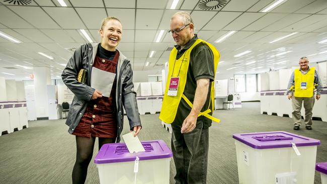 Anke van Bladeren of North Hobart votes early because her shift work as Mat Phipps, the officer in charge of pre poll voting in Hobart, keeps it all official. PICTURE: Eddie Safarik 