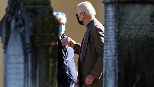 Joe Biden fist bumps a parishioner as he departs St. Joseph on the Brandywine Catholic Church in Wilmington, Delaware, on Saturday. Picture: AFP