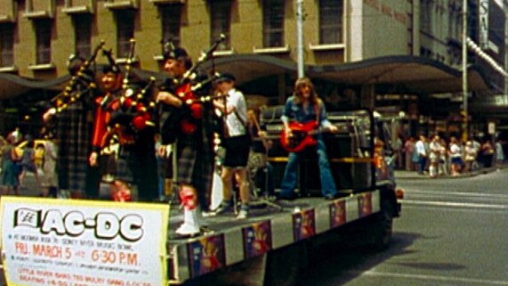 Members of the Rats of Tobruk Pipe Band join AC/DC on the back of a truck on Swanston St to film the clip for <i>It's a Long Way to the Top</i> in 1976. Picture: Albert Music