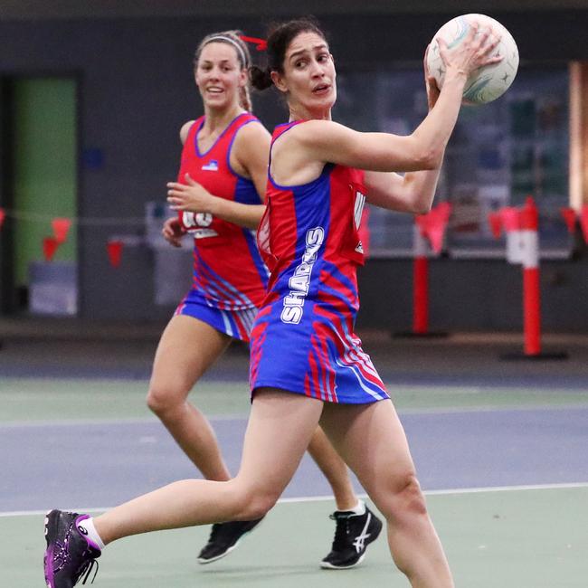 Sharks centre Amanda Barton shifts the ball down the court in the Cairns Netball Association Senior Division 1 match between the Cairns Saints and the WGC Sharks. PICTURE: BRENDAN RADKE