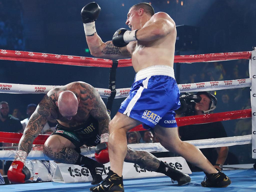 Paul Gallen punches Lucas Browne to the ground.