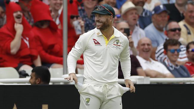 David Warner plays along with the crowd after they asked him what was in his pockets. Picture: Getty Images