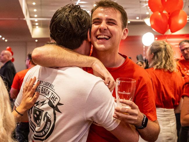 Labor party supporters at Labor HQ at the Village Green in Mulgrave celebrate as the count comes in during the 2022 Victorian State Election. Picture: Jake Nowakowski