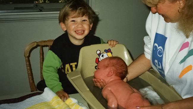 Alcott is bathed by his mum days after being born.