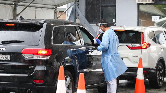 SYDNEY, AUSTRALIA - NewsWire Photos, DECEMBER 23 2021: Health professionals are seen working at the Haberfield Drive through Covid-19  testing clinic as testing demand surges ahead of the holidays in Sydney. Picture: NCA NewsWire / Gaye Gerard