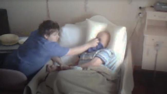 A frame grab from the <i>7.30 Report </i>shows Corey Lyle Lucas with bedridden resident Clarence Hausler.