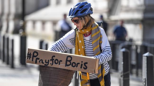 A cyclist with a sign reading '#PrayforBoris' rides through Westminster. Picture: Getty Images