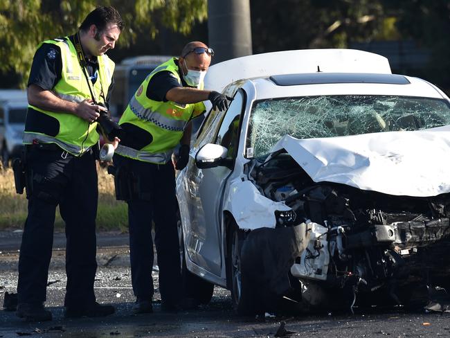 Police look over Yual’s smashed up car. Picture: Nicole Garmston