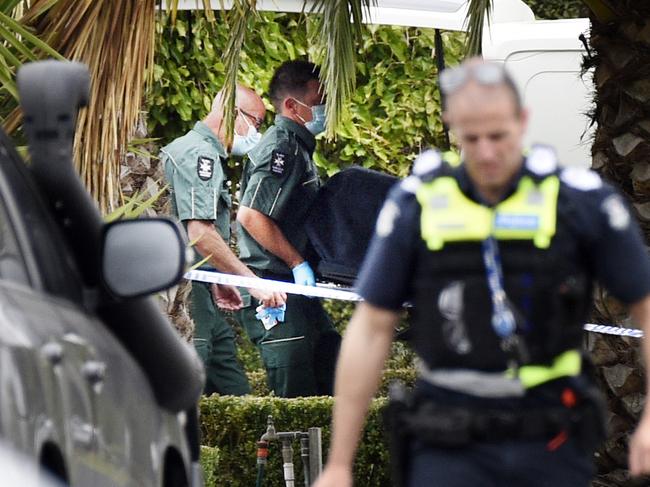 A man’s body is removed from the house on Buchanan Place Greenvale. Picture: Andrew Henshaw