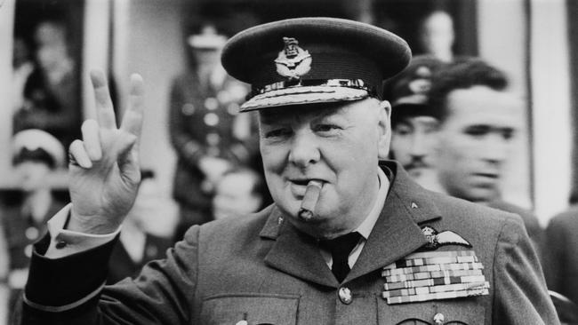 Winston Churchill gives his famous V-sign as he opens a Royal Auxiliary air force squadron headquarters in 1948. (Photo by Central Press/Hulton Archive/Getty Images)