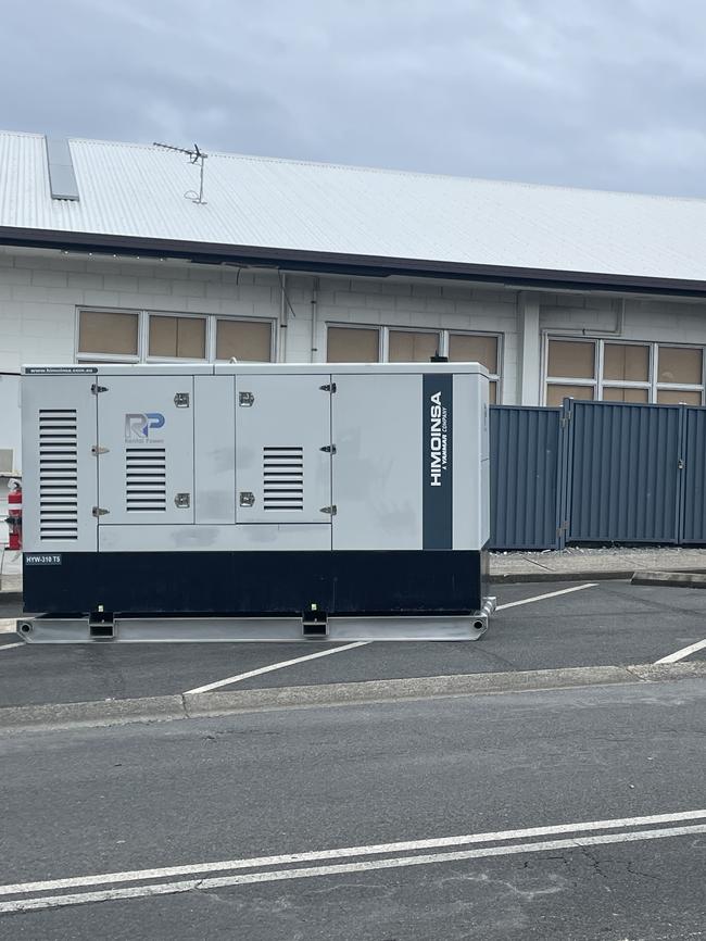 Windows boarded up and a generator on standby at Paradise Point Bowls Club.