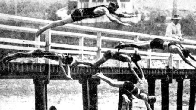 People diving from the Dee Why Lagoon footbridge in 1925