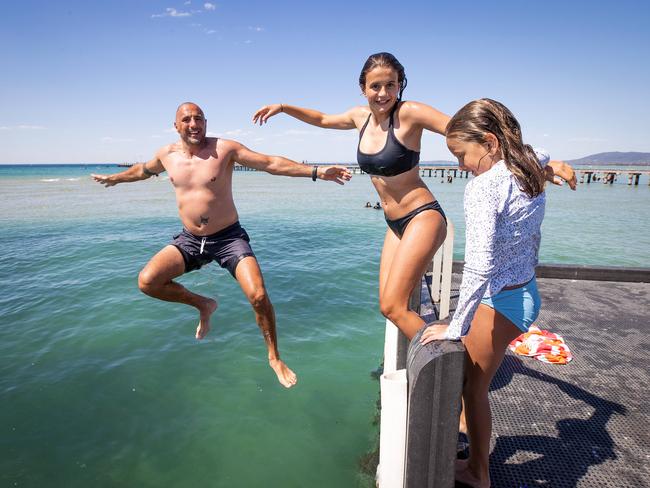 John Rousakis with daughters Amelia, 13, and Stephanie, 8, at Rye on New Year’s Eve. Picture: Mark Stewart