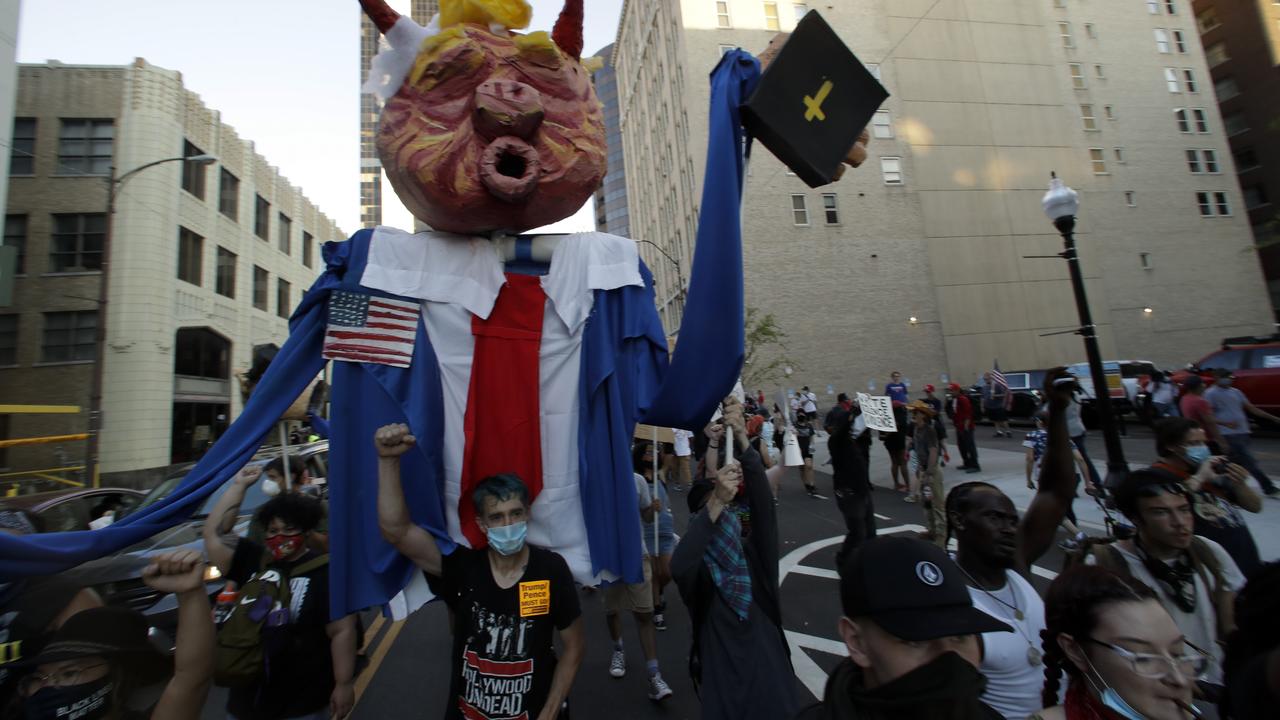 Demonstrators march near the BOK Center where President Trump is holding a campaign rally in Tulsa. Picture: AP Photo/Charlie Riedel