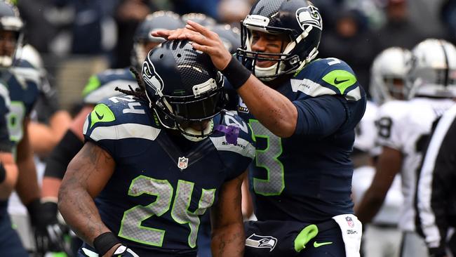 Quarterback Russell Wilson celebrates with running back Marshawn Lynch.