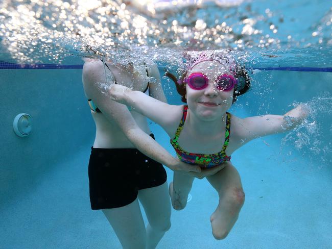 Mia leads as normal a life as possible and loves swimming. Picture: Adam Head