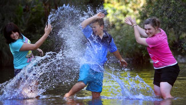 Hannah Reedman, Blake Wardle and Paige Graham keeping cool in a creek at Amamoor State Forest.