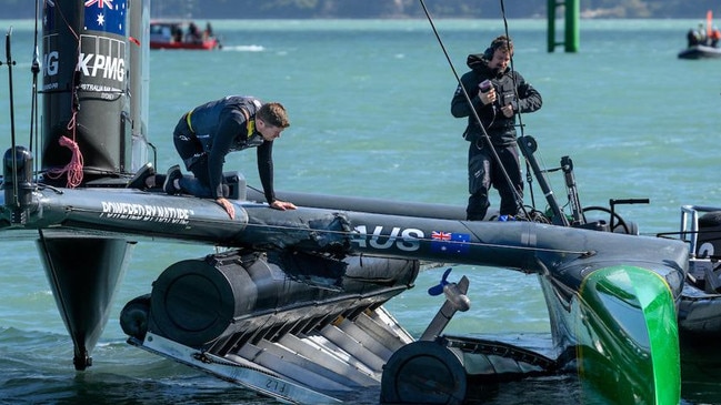 Tom Slingsby looks over the damage sustained to the F50 a finish line marker in Christchurch. Photo: Ricardo Pinto for SailGP.