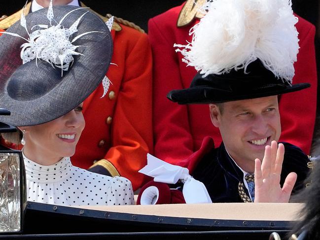 The royal couple wave to fans. Picture: AFP