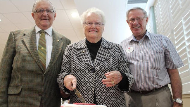 John Adams, Shirley Adams and Bob McFarlane cut the cake at the Red Cross centenary celebrations in Grafton. Picture: Clair Morton.