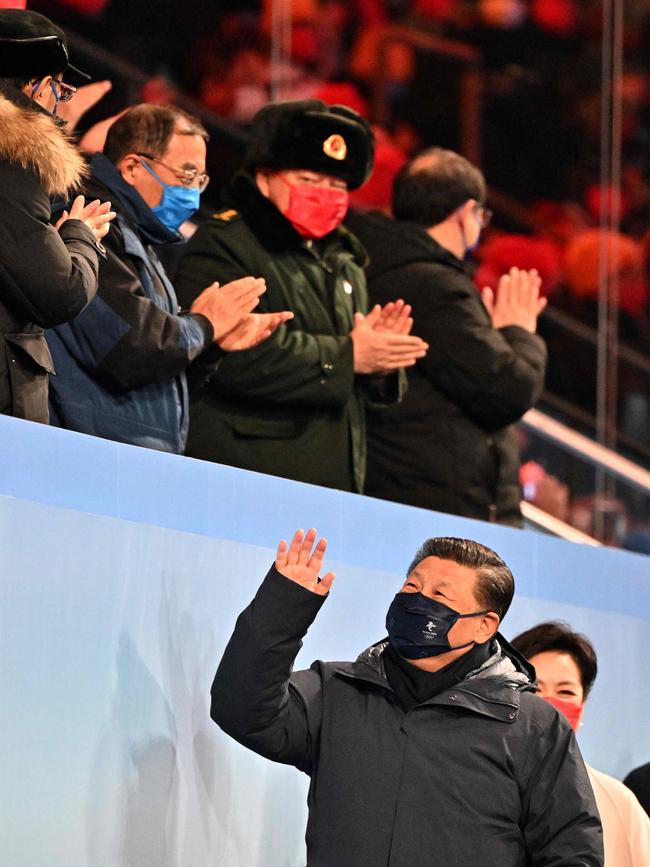 Xi Jinping (L) and his wife Peng Liyuan (R) greet attendees during the opening ceremony of the Beijing 2022 Winter Olympic Games.